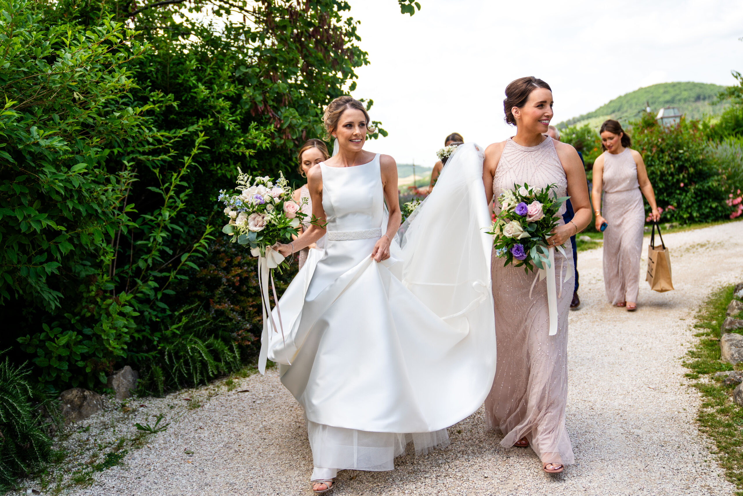 London destination wedding photographer captured the bride and bridesmaids walking through Italian wedding venue in Assisi 
