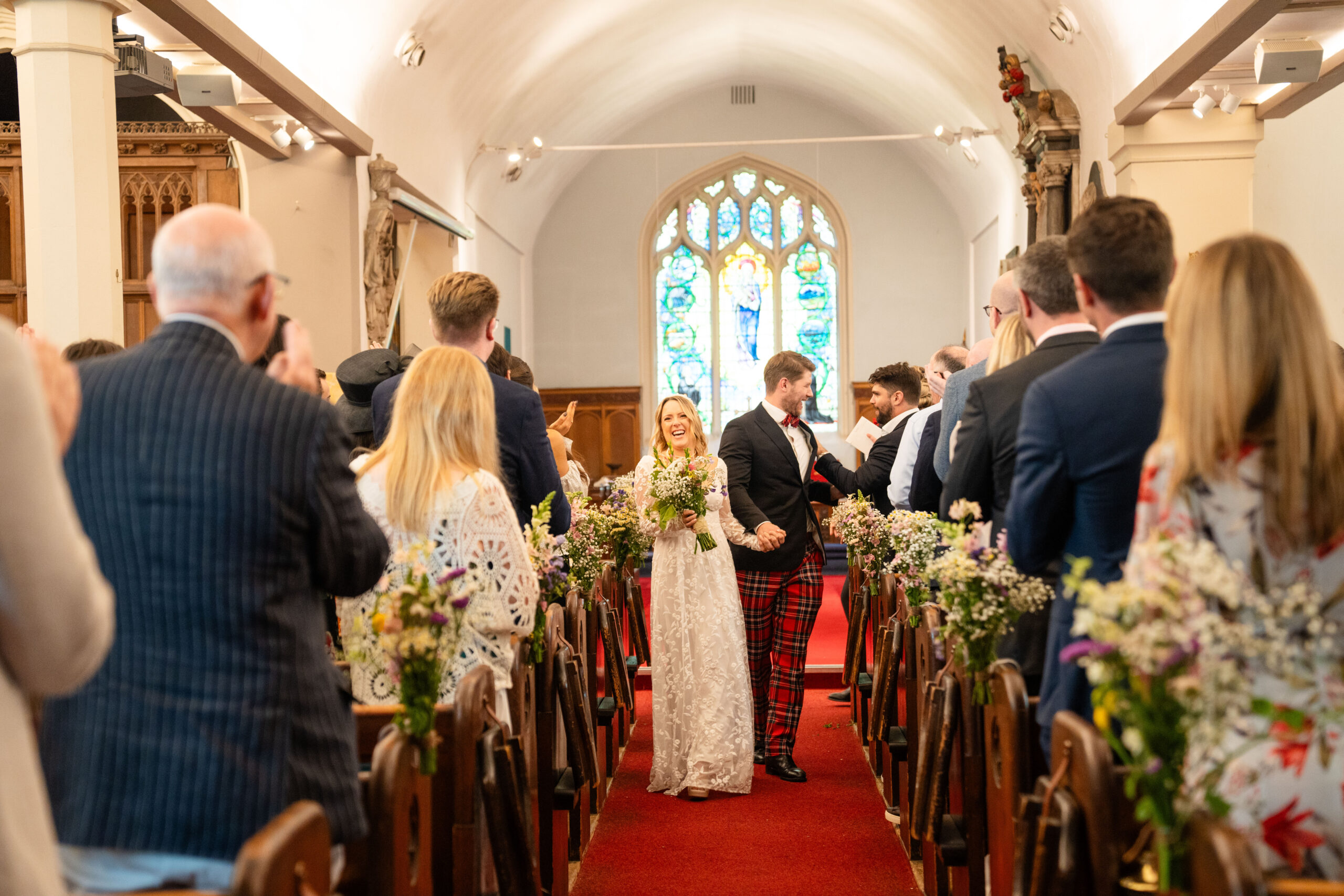 walking down the church isle married couple in Richmond photographed by Richmond wedding photographer