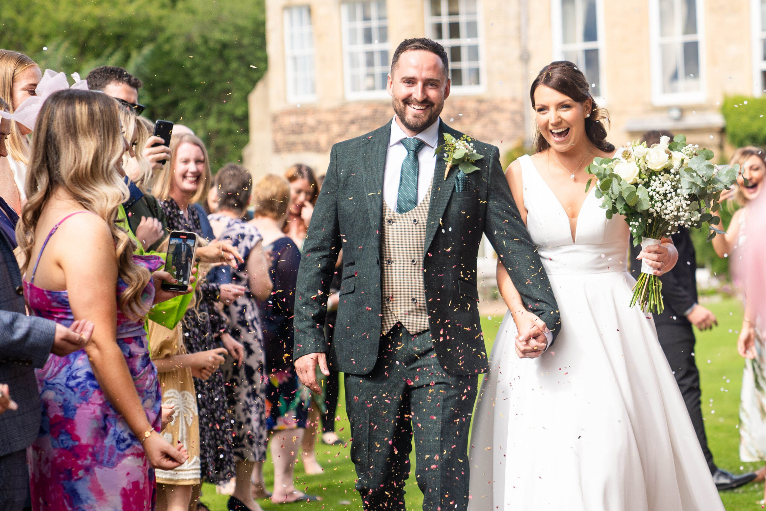 Confetti exit with the house in the background captured by Hooton Pagnell Wedding Photographer 